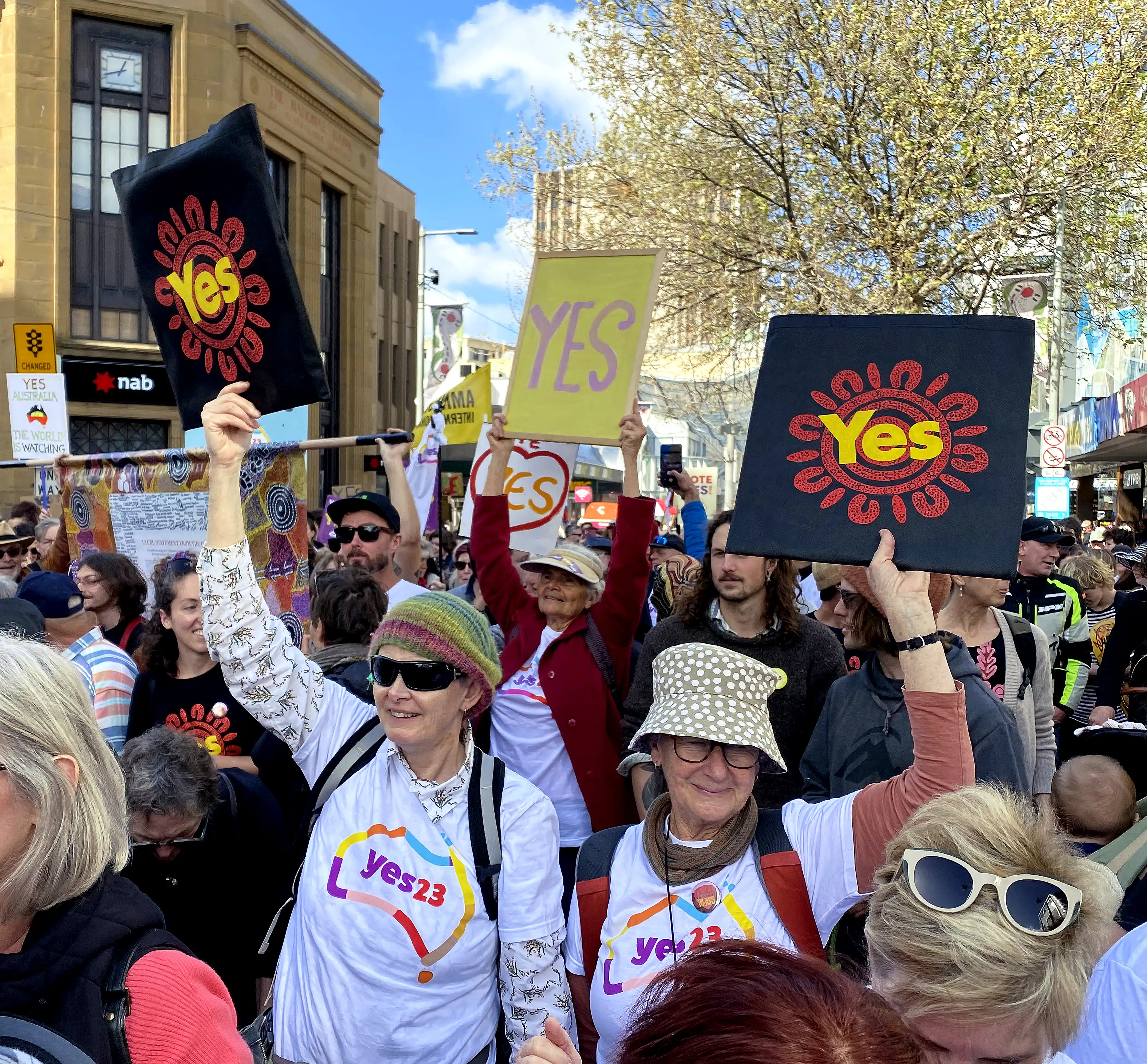 Picture taken at a Voice Rally in the Hobart CBD showing a colourful crowd of participants wearing ‘Yes 23’ t-shirts and holding ‘Yes’ placards.